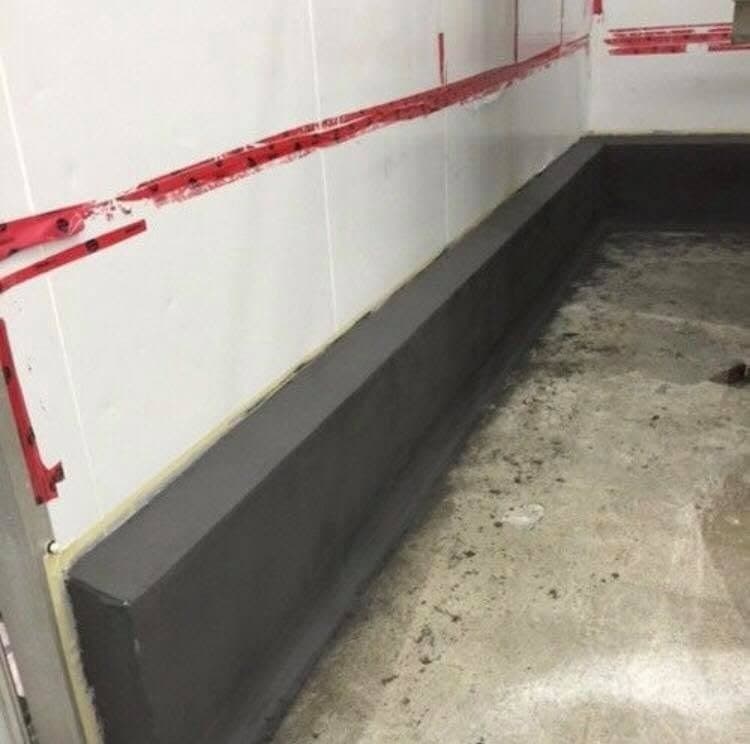 Coved epoxy base where the floor meets the wall