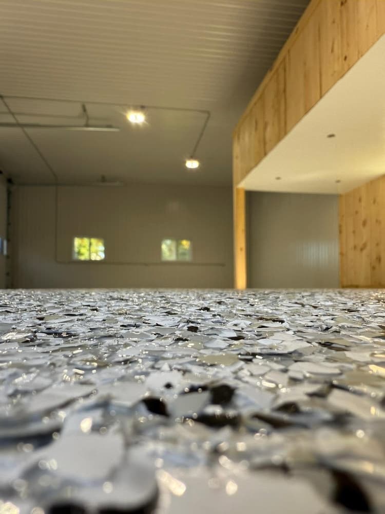 Close-up of a grey, black and white flake epoxy floor